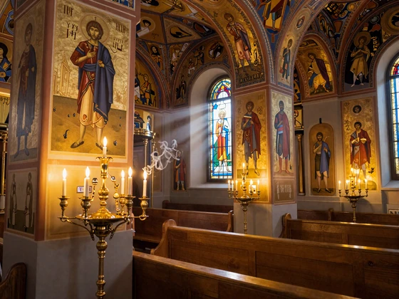 Interior of a Serbian Orthodox church with golden Byzantine icons and candlelight reflecting orthodox christian dating values