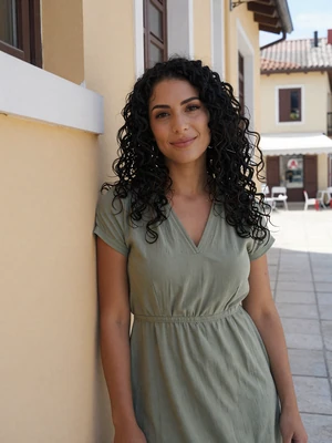 Besarta, 26-year-old verified Albanian woman from Durrës with curly black hair in coastal setting